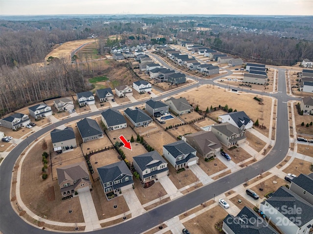 birds eye view of property featuring a residential view and a view of trees