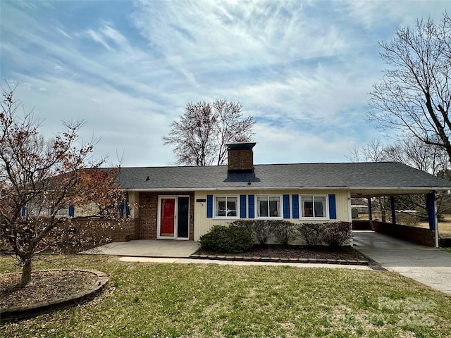 ranch-style house with brick siding, a chimney, a carport, driveway, and a front lawn