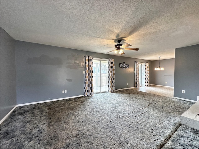 carpeted spare room featuring ceiling fan with notable chandelier, a textured ceiling, and baseboards