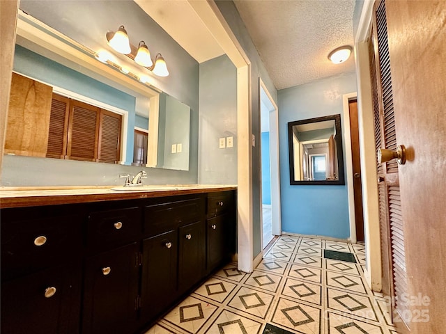 bathroom with a textured ceiling and vanity