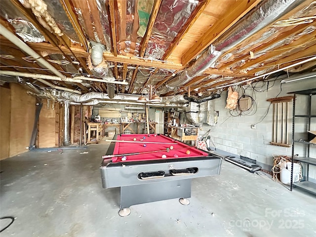 rec room featuring concrete block wall, concrete floors, and billiards