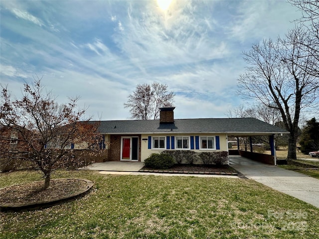 single story home featuring concrete driveway, a carport, a chimney, and a front yard