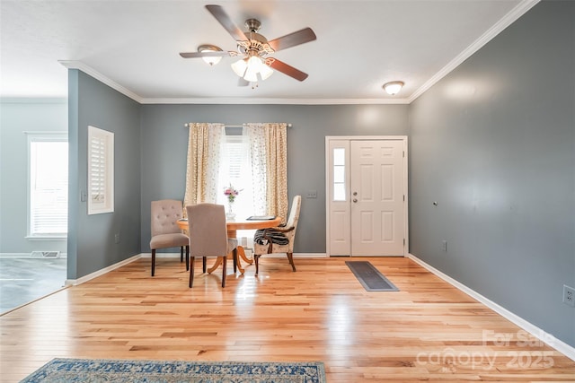 entrance foyer featuring light wood-style flooring, baseboards, ceiling fan, and ornamental molding