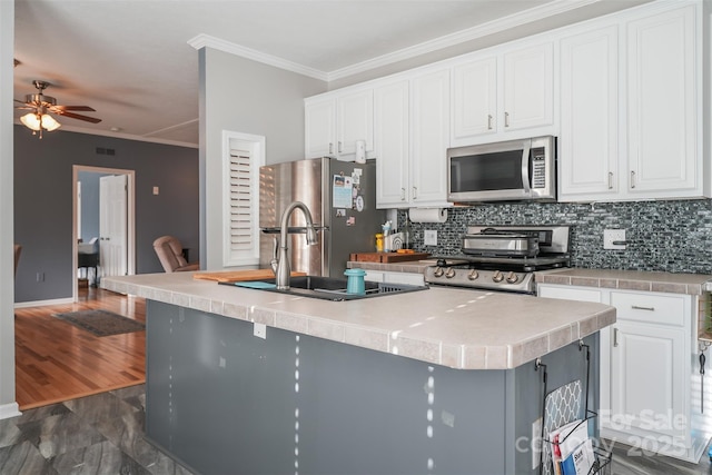 kitchen featuring crown molding, white cabinetry, stainless steel appliances, and a sink