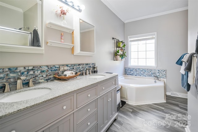 bathroom featuring ornamental molding, visible vents, and a sink