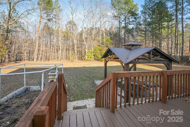 wooden terrace with a gazebo and a forest view