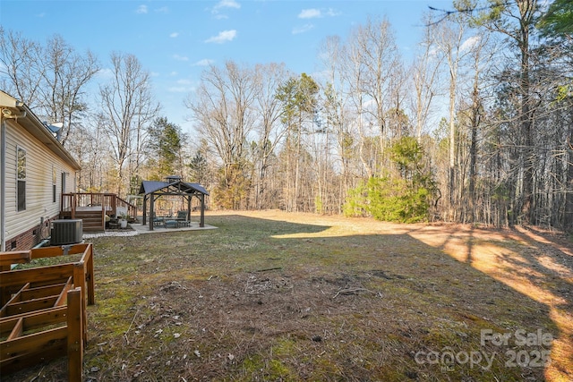 view of yard with a wooden deck and central AC unit