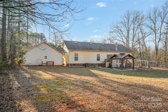 back of property with a gazebo, a yard, crawl space, and a patio