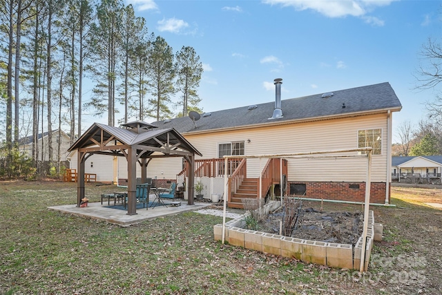 back of house featuring a shingled roof, a gazebo, crawl space, a vegetable garden, and a patio area