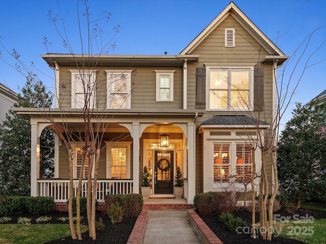 traditional home featuring covered porch