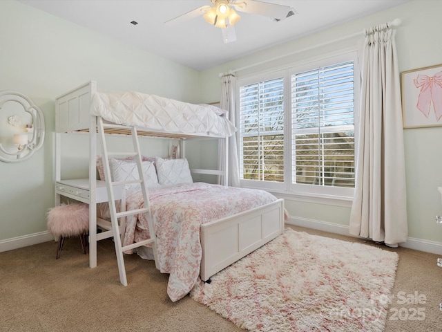 bedroom with a ceiling fan, baseboards, and carpet flooring