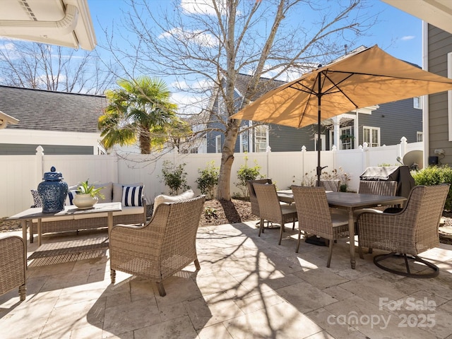 view of patio featuring outdoor dining space, a fenced backyard, and an outdoor living space