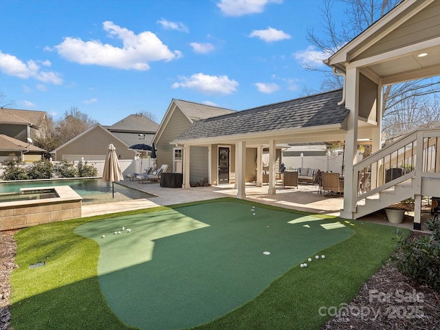 exterior space with an outdoor pool, roof with shingles, a patio, and fence