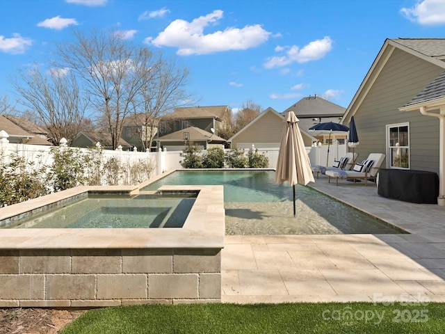 view of swimming pool featuring a fenced backyard, a fenced in pool, a patio, and an in ground hot tub