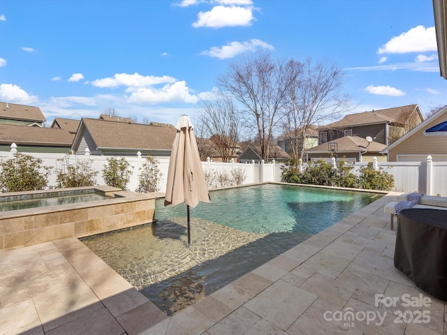 view of swimming pool with an in ground hot tub, a patio area, a fenced backyard, and a fenced in pool