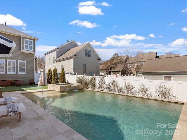 view of pool featuring a pool with connected hot tub, a patio area, and a fenced backyard