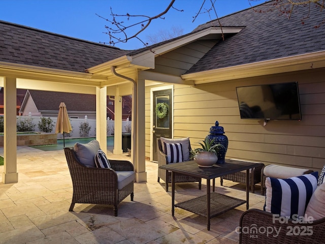 view of patio / terrace with outdoor lounge area, fence, and an outdoor pool