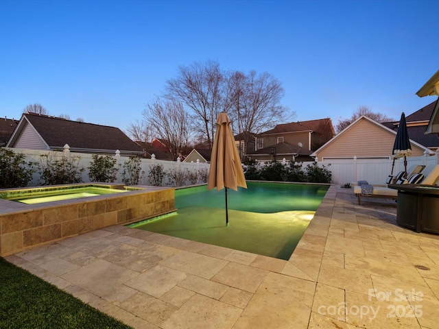 view of pool featuring a patio, a fenced backyard, and an in ground hot tub