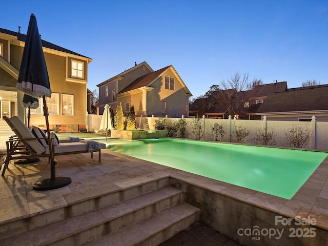 view of pool featuring a patio, a fenced backyard, and a fenced in pool