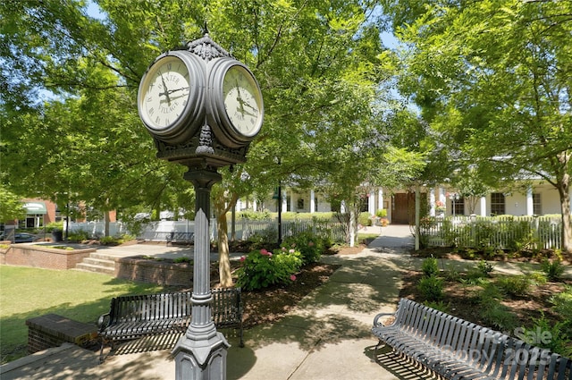 surrounding community featuring fence and a lawn