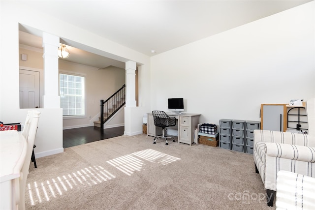 carpeted office featuring decorative columns and baseboards