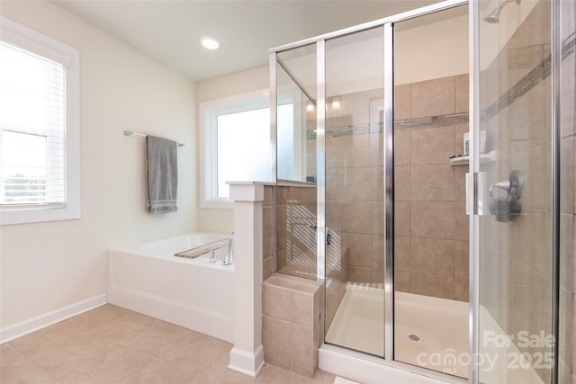 full bath with a shower stall, baseboards, a bath, and tile patterned floors