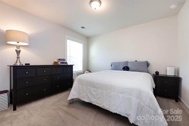 bedroom featuring light carpet, visible vents, and baseboards