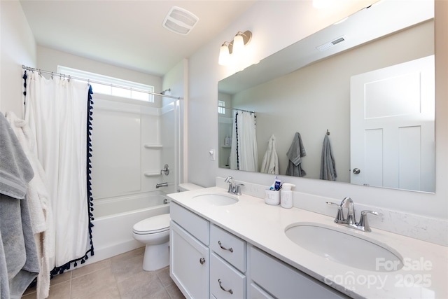 bathroom featuring tile patterned flooring, visible vents, and a sink