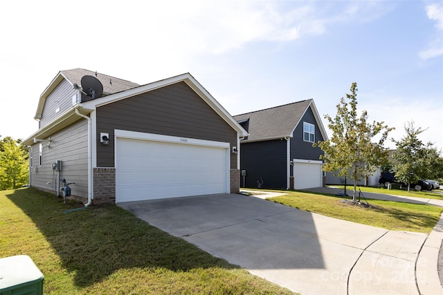 view of front of house featuring a garage, a front yard, and driveway