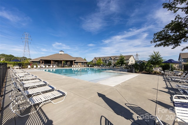 pool with fence and a patio