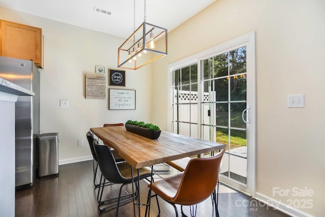 dining room with baseboards, dark wood finished floors, and a wealth of natural light