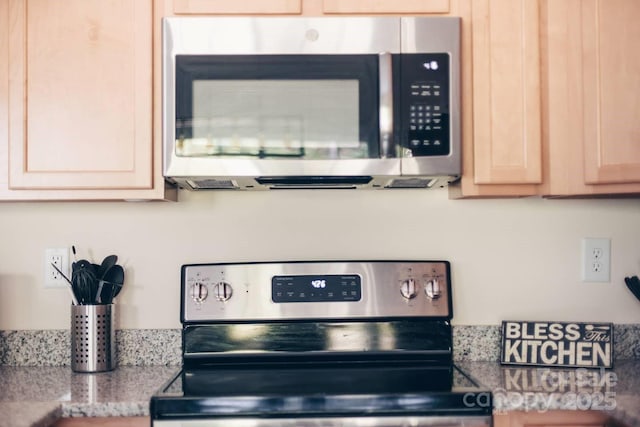 details featuring stainless steel appliances, light countertops, and light brown cabinetry