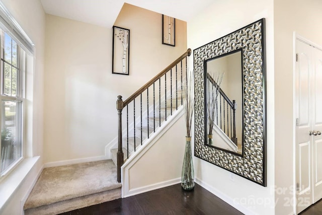 stairs with baseboards and wood finished floors