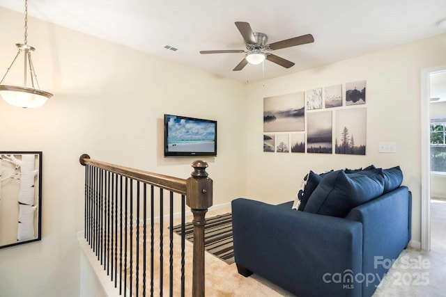 living area featuring carpet, visible vents, and baseboards