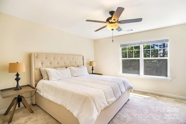 bedroom with visible vents, ceiling fan, light carpet, and baseboards