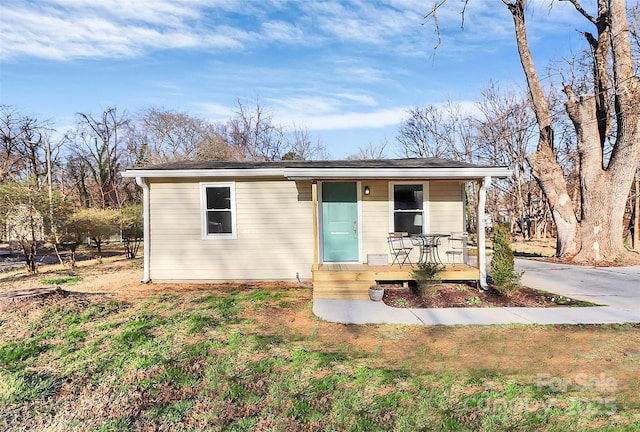 view of front of home with a porch and a front yard