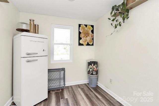 interior space featuring dark wood finished floors and baseboards