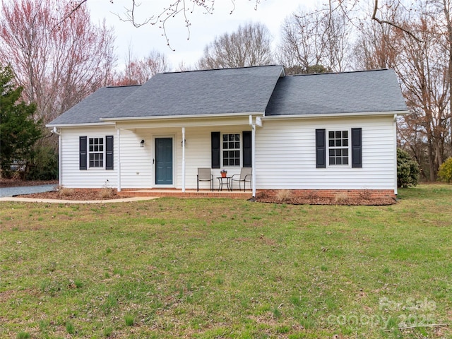 ranch-style home featuring crawl space, a shingled roof, a porch, and a front lawn