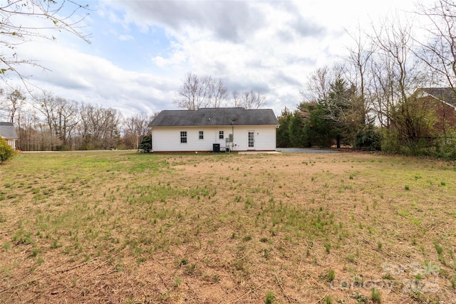 rear view of property featuring a lawn