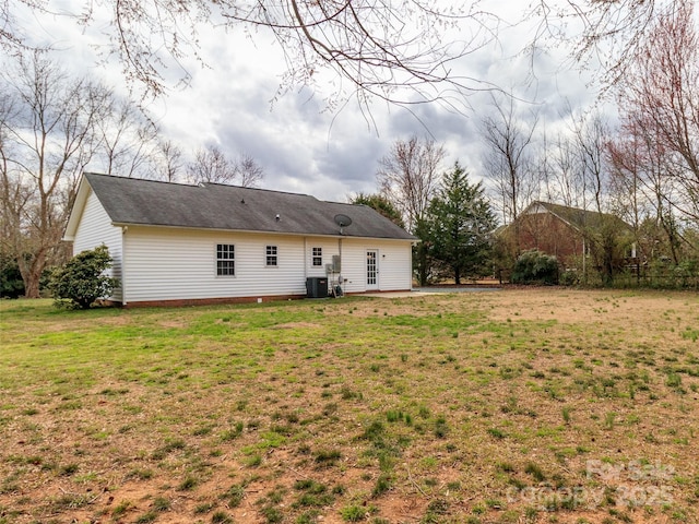 rear view of property featuring central AC, a lawn, and a patio