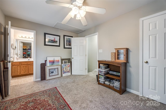 playroom with attic access, a ceiling fan, carpet flooring, a sink, and baseboards