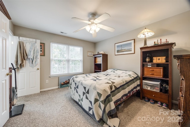 bedroom featuring a ceiling fan, carpet, visible vents, and baseboards