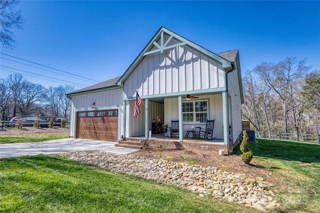 modern inspired farmhouse with covered porch, board and batten siding, driveway, and a garage