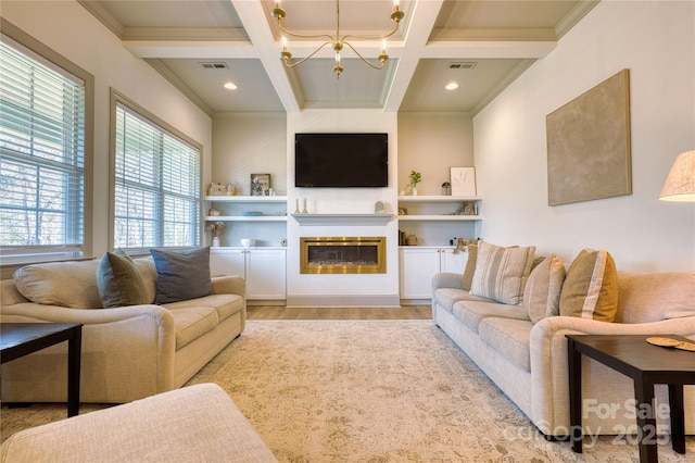 living area with light wood finished floors, visible vents, coffered ceiling, and an inviting chandelier