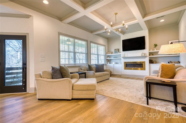 living room featuring an inviting chandelier, visible vents, coffered ceiling, and light wood-type flooring