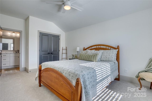 bedroom with light carpet, a ceiling fan, baseboards, and vaulted ceiling