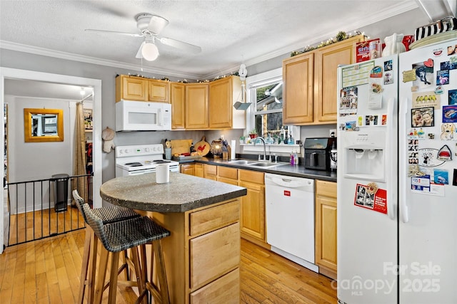 kitchen with white appliances, crown molding, light wood-style floors, and a sink