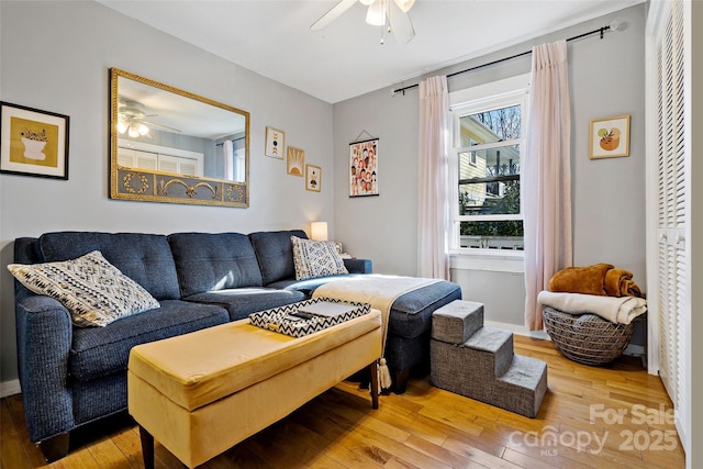 living room featuring ceiling fan and hardwood / wood-style floors