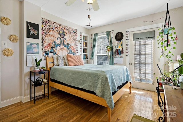 bedroom featuring a ceiling fan, baseboards, and wood-type flooring