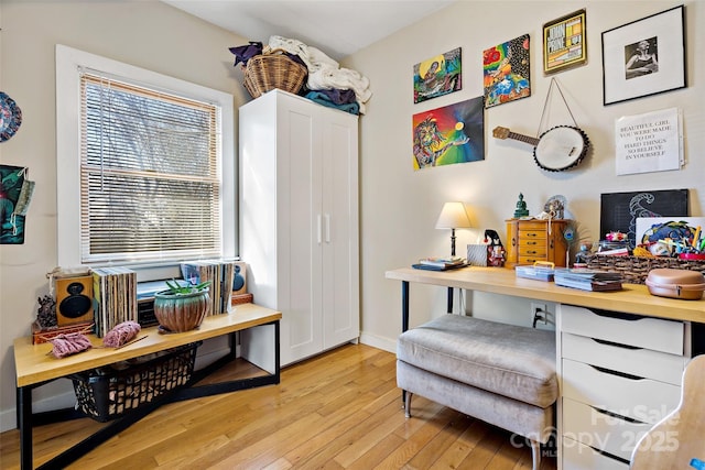 home office featuring baseboards and light wood-style floors